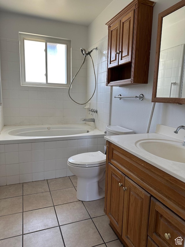 bathroom featuring tile patterned floors, toilet, tiled shower / bath combo, and vanity