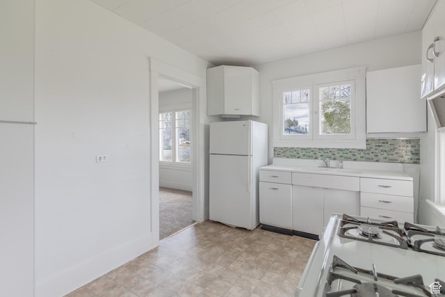 98 S Center St, Redmond, UT 84652 - kitchen with white appliances, light countertops, white cabinetry, backsplash, and a sink