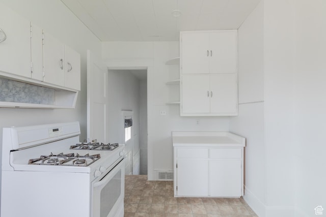98 S Center St, Redmond, UT 84652 - kitchen featuring white range with gas stovetop, open shelves, light countertops, and white cabinets