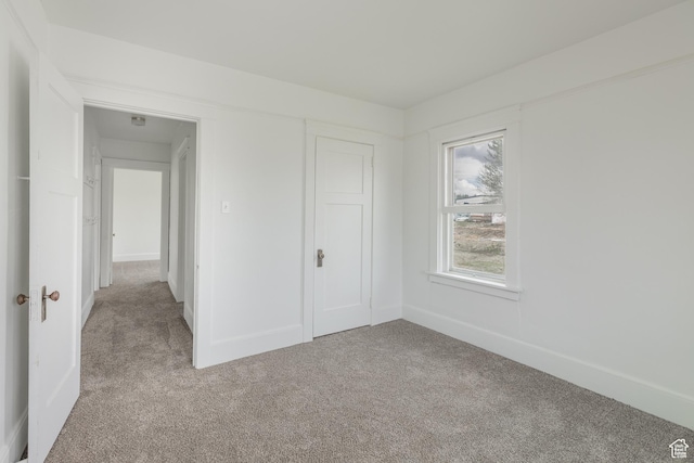 98 S Center St, Redmond, UT 84652 - unfurnished bedroom featuring light carpet, baseboards, and a closet