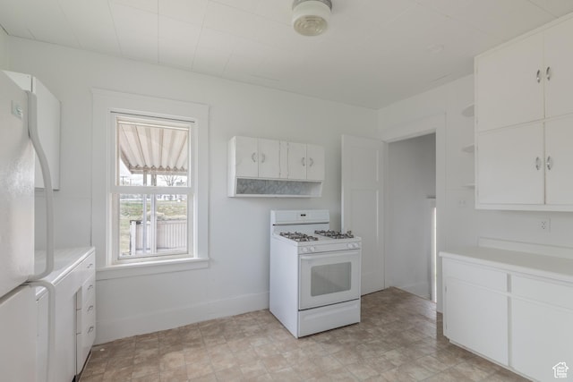 98 S Center St, Redmond, UT 84652 - kitchen with white appliances, light countertops, white cabinets, and open shelves