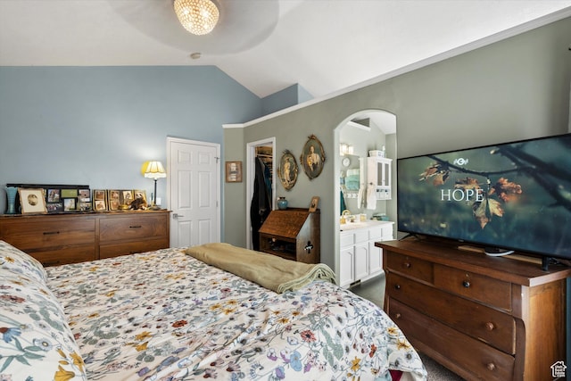 3347 N 1150 E, Layton, UT 84040 - bedroom featuring arched walkways, lofted ceiling, a sink, a spacious closet, and ensuite bath
