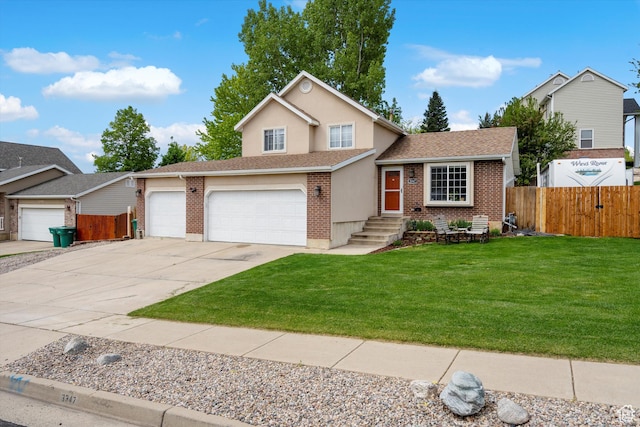 3347 N 1150 E, Layton, UT 84040 - tri-level home with driveway, brick siding, an attached garage, and a shingled roof
