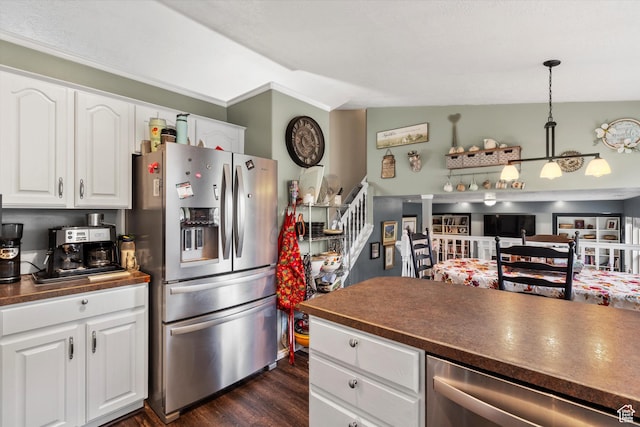 3347 N 1150 E, Layton, UT 84040 - kitchen featuring appliances with stainless steel finishes, dark countertops, dark wood-style flooring, white cabinetry, and decorative light fixtures