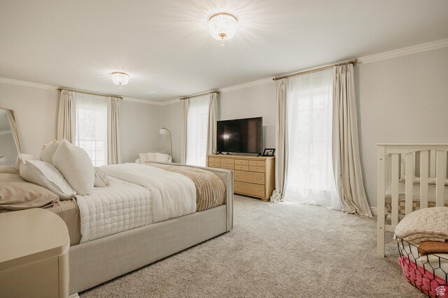 bedroom with crown molding and light carpet