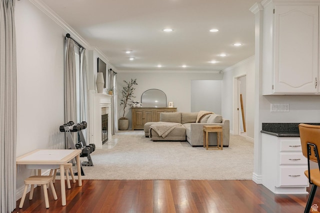 living area with ornamental molding, dark wood-style flooring, a fireplace with flush hearth, recessed lighting, and baseboards