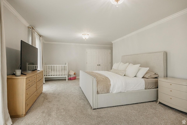 bedroom featuring ornamental molding, light carpet, and a closet