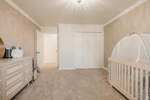 bedroom with light colored carpet, crown molding, a closet, and baseboards