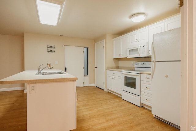 kitchen featuring white appliances, a sink, light wood-type flooring, white cabinetry, and light countertops