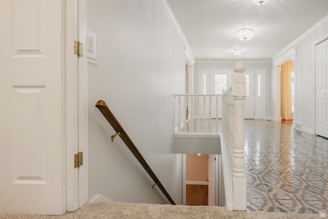 staircase featuring crown molding and baseboards