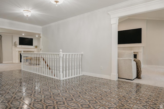 empty room featuring a fireplace, crown molding, baseboards, and carpet flooring