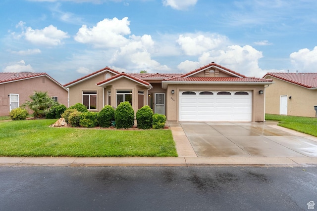 view of front facade featuring a tiled roof, concrete driveway, stucco siding, and a garage