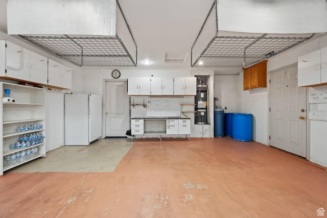 garage with secured water heater and freestanding refrigerator