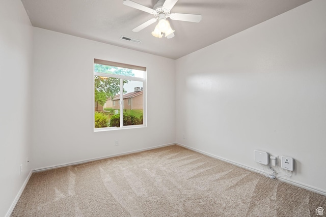 carpeted empty room with baseboards and ceiling fan