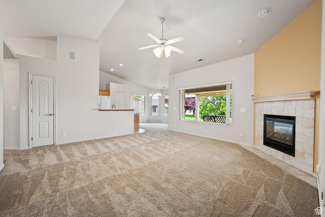 unfurnished living room with carpet flooring, lofted ceiling, a fireplace, a ceiling fan, and baseboards