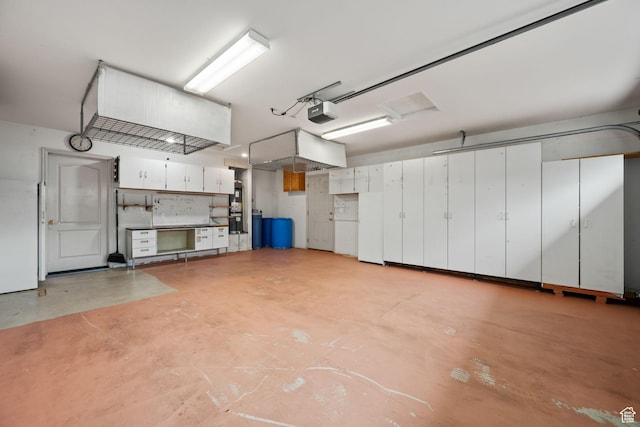 garage featuring a garage door opener and freestanding refrigerator
