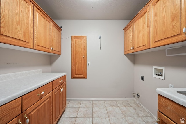 laundry room featuring cabinet space, hookup for a washing machine, hookup for an electric dryer, and baseboards