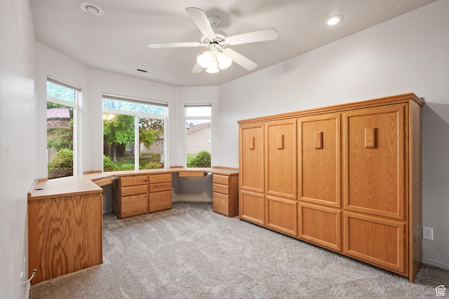 unfurnished office with light carpet, ceiling fan, recessed lighting, built in study area, and baseboards