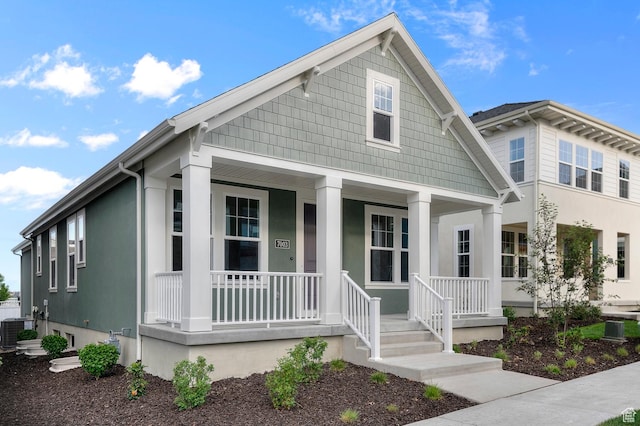 view of front of house with covered porch and central AC