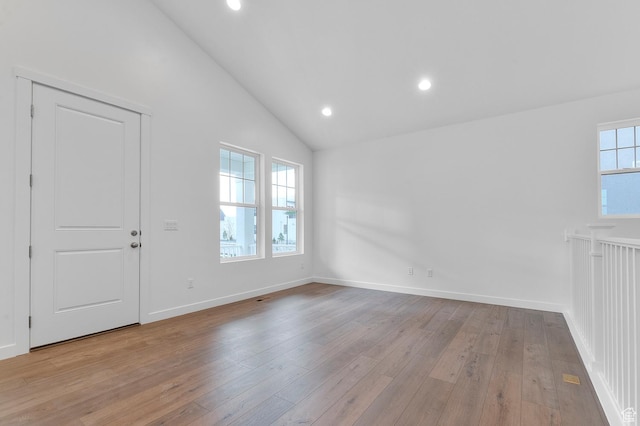 empty room with light wood-style floors, vaulted ceiling, recessed lighting, and baseboards