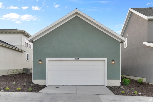 garage featuring cooling unit and concrete driveway