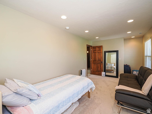 bedroom featuring light colored carpet and recessed lighting