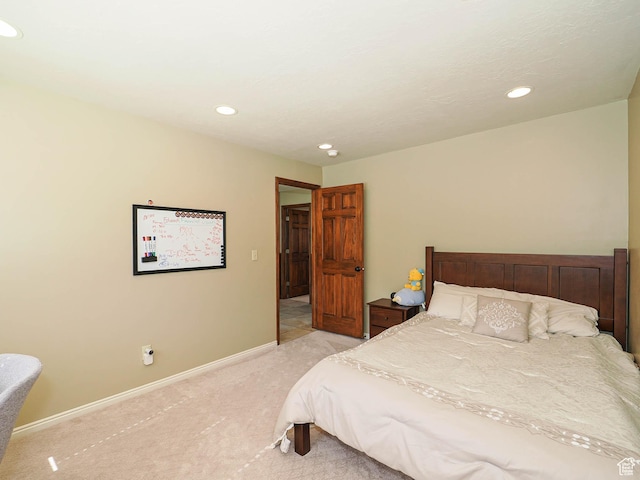 bedroom featuring light carpet, recessed lighting, and baseboards