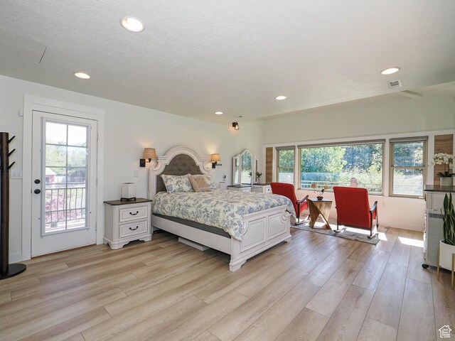 bedroom with light wood-type flooring, access to outside, and recessed lighting