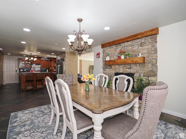 dining area with a chandelier, recessed lighting, baseboards, and a fireplace