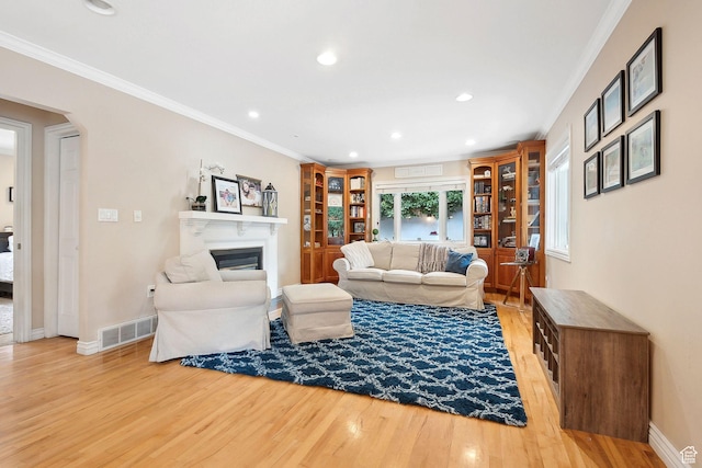 2625 E Kentucky Ave, Holladay, UT 84117 - living room featuring light wood-style floors, crown molding, a glass covered fireplace, recessed lighting, and baseboards