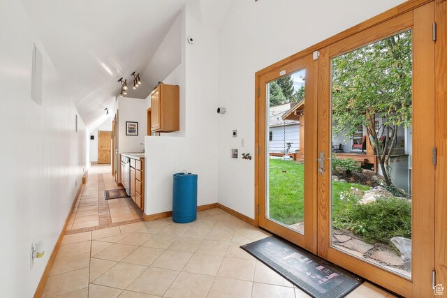 2625 E Kentucky Ave, Holladay, UT 84117 - doorway featuring light tile patterned floors, vaulted ceiling, and baseboards