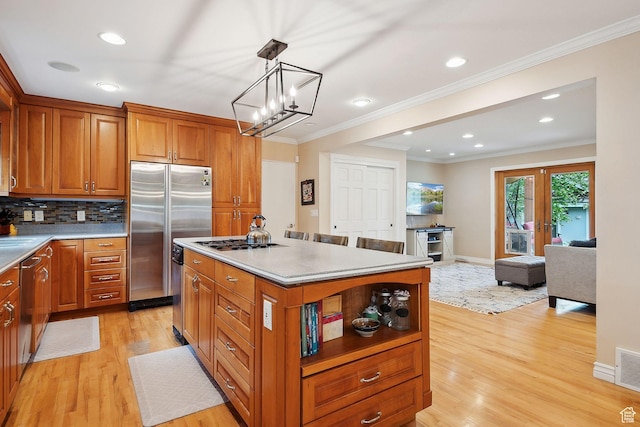 2625 E Kentucky Ave, Holladay, UT 84117 - kitchen with appliances with stainless steel finishes, light wood-style floors, brown cabinetry, a center island, and ornamental molding