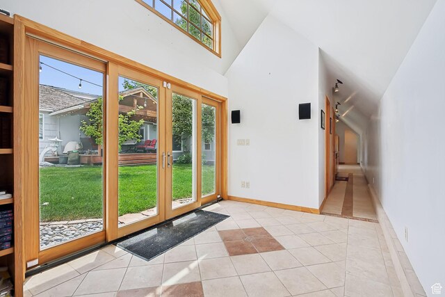 2625 E Kentucky Ave, Holladay, UT 84117 - doorway with light tile patterned floors, high vaulted ceiling, and baseboards