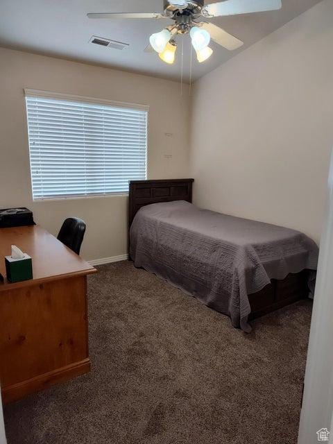 bedroom with carpet, baseboards, an office area, and a ceiling fan
