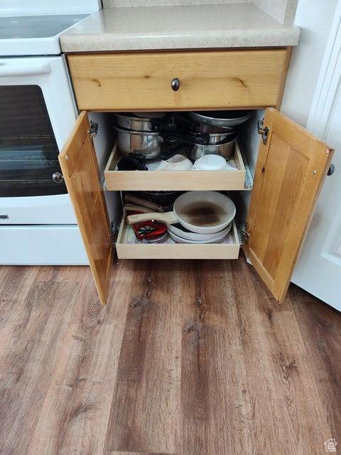 kitchen view of electric range and wood finished floors