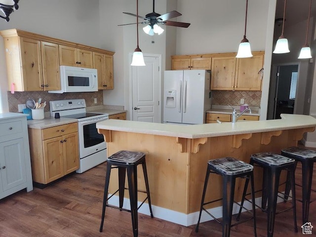 kitchen featuring white appliances, backsplash, ceiling fan, dark wood-style flooring, and a high ceiling