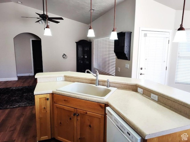 kitchen with white dishwasher, a sink, vaulted ceiling, dark wood-style flooring, and a ceiling fan