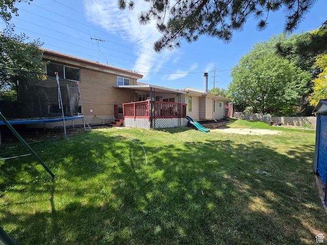 614 W Anderson Ave S, Murray, UT 84123 - view of yard featuring a trampoline and a wooden deck