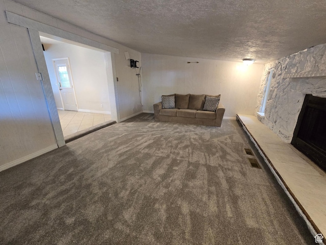 614 W Anderson Ave S, Murray, UT 84123 - unfurnished living room with a textured ceiling, a fireplace, and carpet flooring