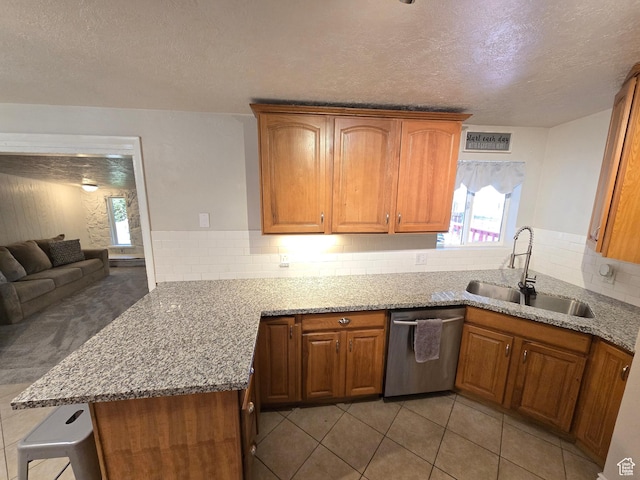 614 W Anderson Ave S, Murray, UT 84123 - kitchen featuring stainless steel dishwasher, a peninsula, a textured ceiling, light stone countertops, and brown cabinetry
