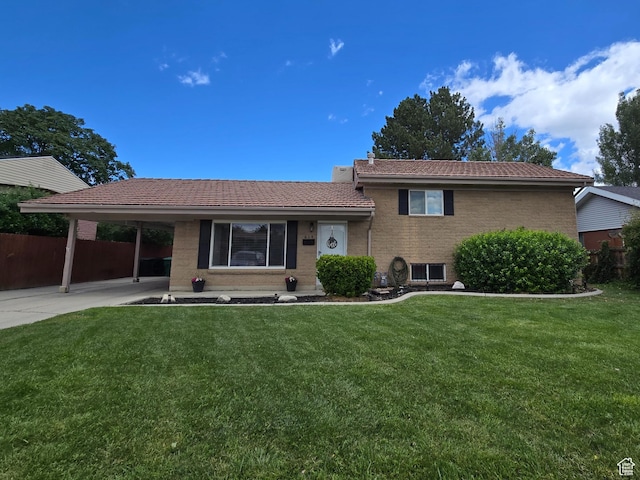 614 W Anderson Ave S, Murray, UT 84123 - back of property with a tile roof, brick siding, an attached carport, and concrete driveway