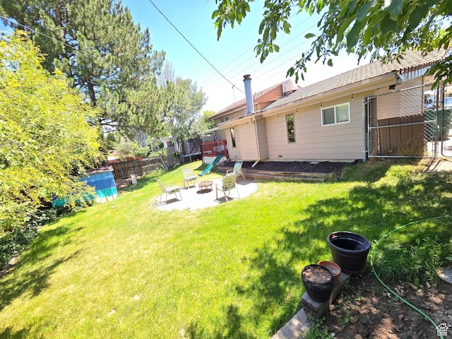 614 W Anderson Ave S, Murray, UT 84123 - view of yard with a patio area and a trampoline