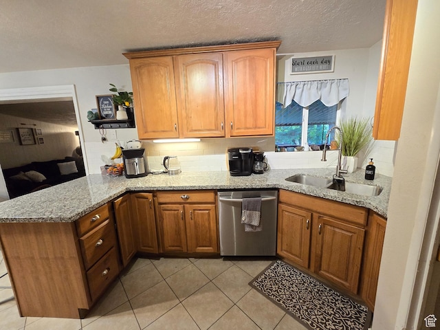 kitchen featuring stainless steel dishwasher, a sink, a peninsula, light tile patterned flooring, and light stone countertops