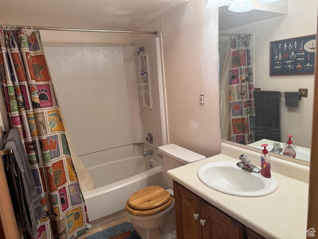bathroom with toilet, shower / tub combo, and vanity