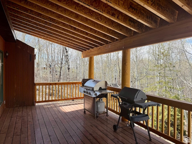 wooden terrace with grilling area and a forest view
