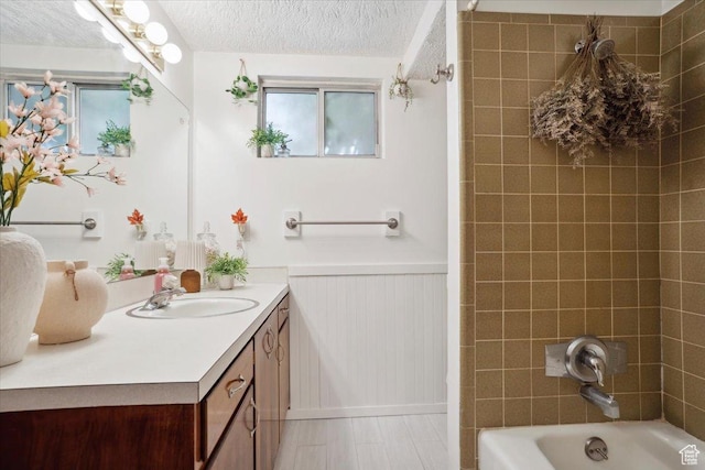 2884 N 300 E, North Ogden, UT 84414 - full bath with vanity, wainscoting, shower / bathtub combination, and a textured ceiling