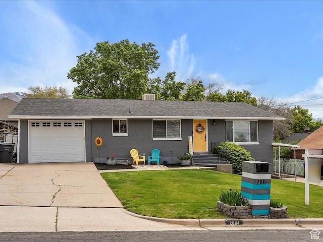 2884 N 300 E, North Ogden, UT 84414 - view of front of house featuring an attached garage, concrete driveway, and a front lawn