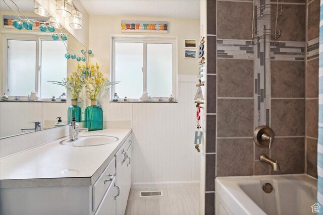 2884 N 300 E, North Ogden, UT 84414 - bathroom with vanity, healthy amount of natural light, bathing tub / shower combination, wainscoting, and baseboards