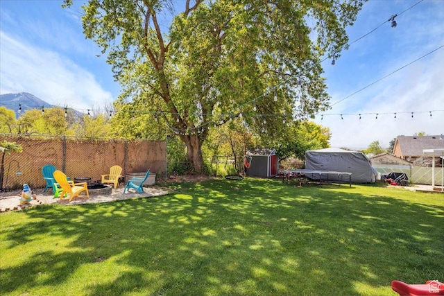 2884 N 300 E, North Ogden, UT 84414 - view of yard with a fire pit, a storage unit, an outbuilding, and a mountain view