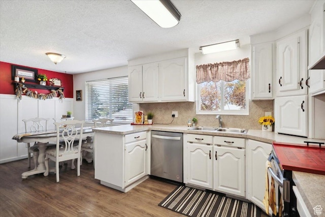 2884 N 300 E, North Ogden, UT 84414 - kitchen with appliances with stainless steel finishes, a sink, white cabinets, a textured ceiling, and wood finished floors